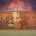 "In DIFFERENZA" Spray e smalto su parete 21x9 m Nurallao 2025